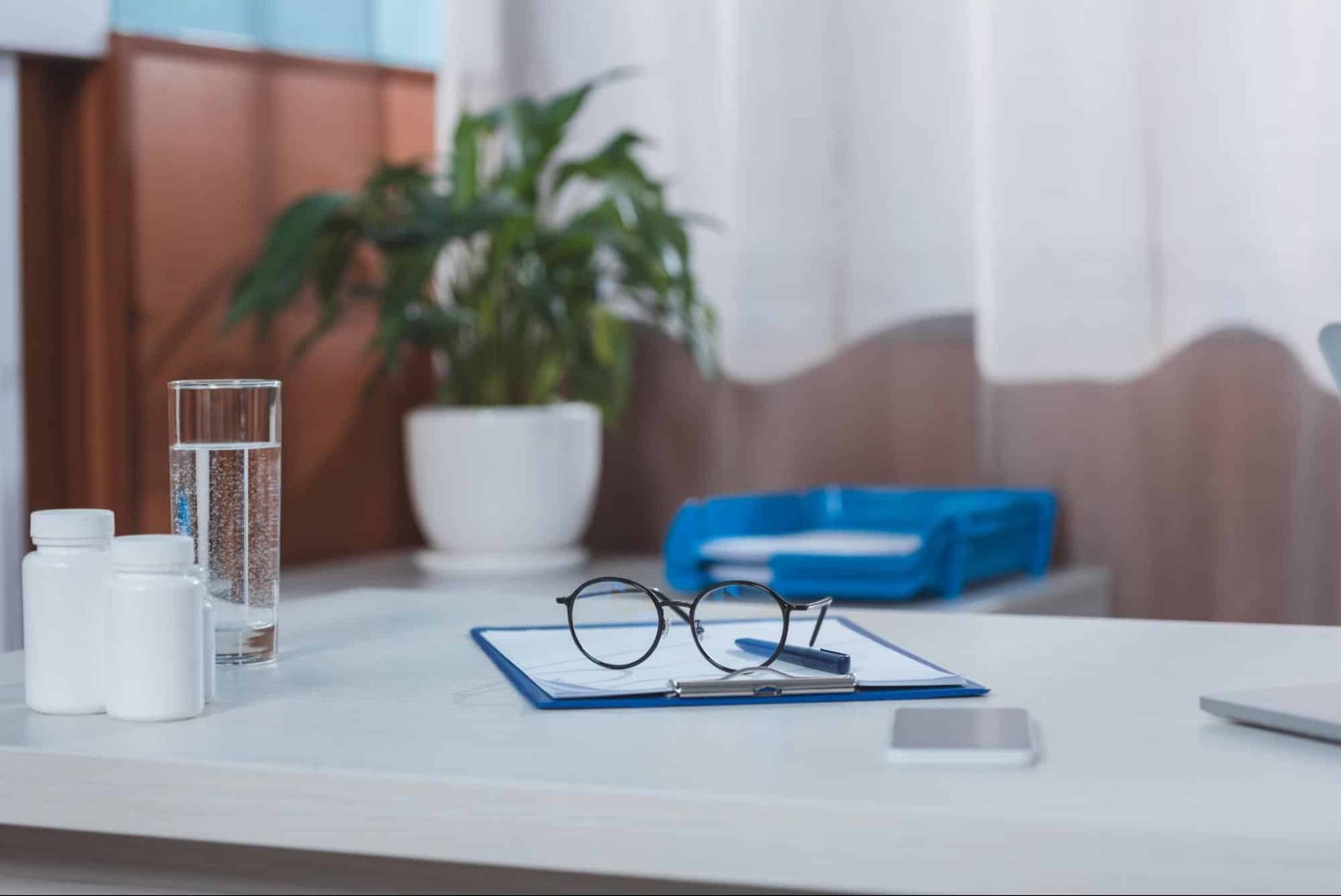 table with medical records, eyeglasses, in a clinic