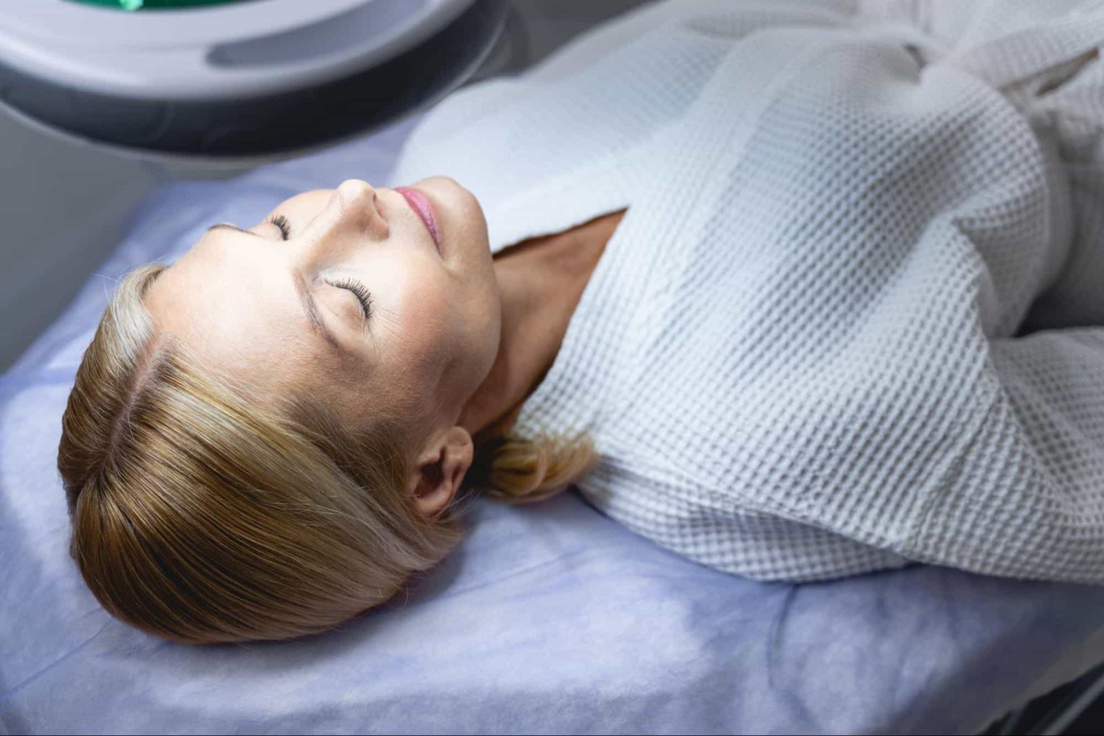 woman being checked under bright lights, representing the services of an aesthetic clinic in Weslaco, TX