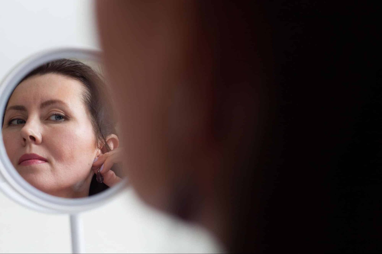 woman looking at herself in a mirror