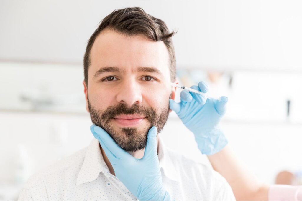 man receiving facial injections, representing the curiosity behind the question “where to find an aesthetic clinic in Weslaco?”