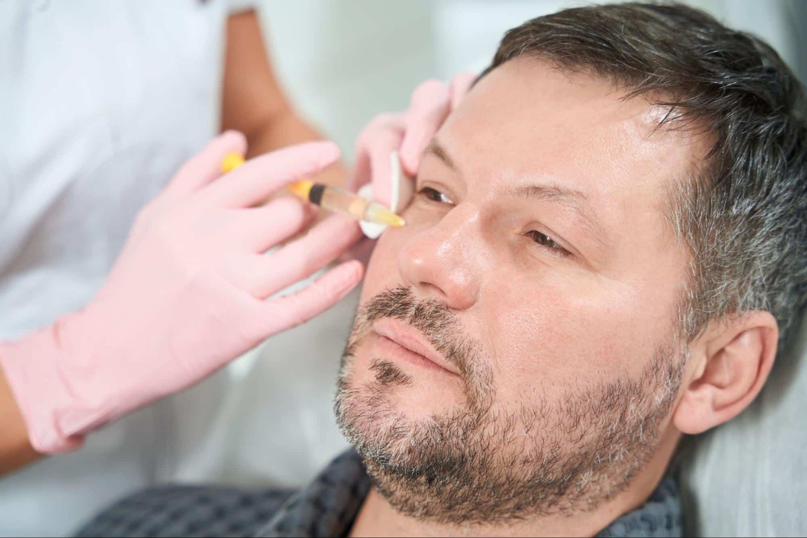 man receiving facial injection