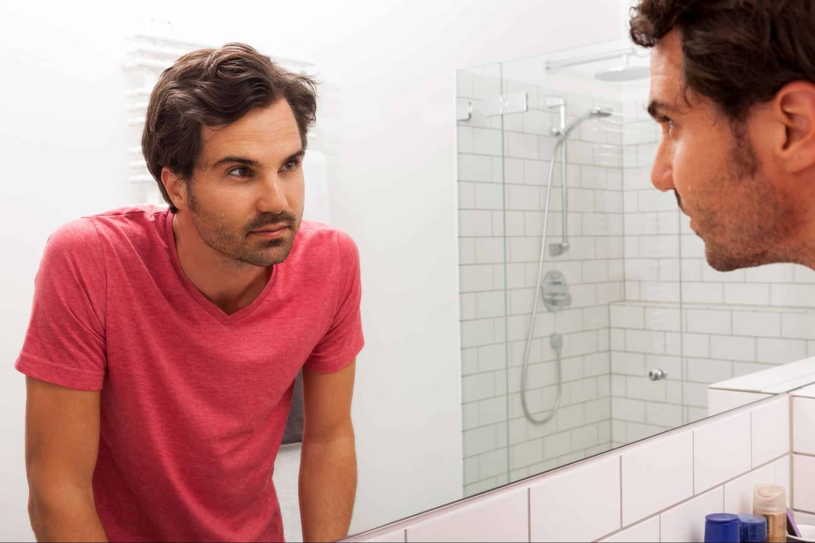 man looking at himself in mirror