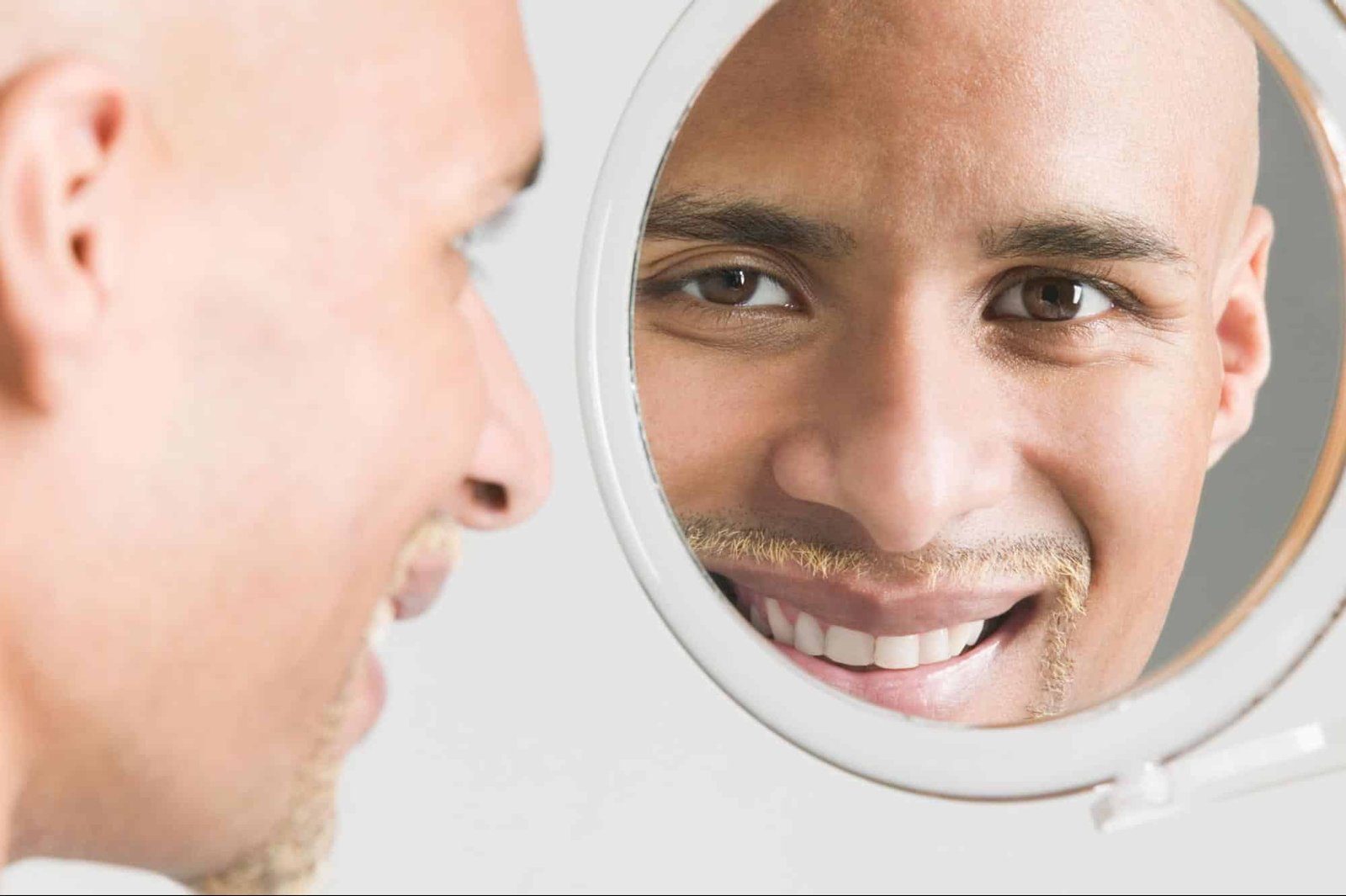man looking at himself in a mirror