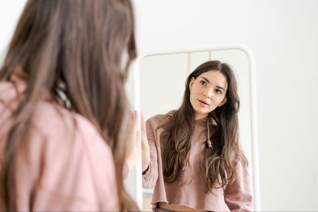 woman looking at herself in a mirror