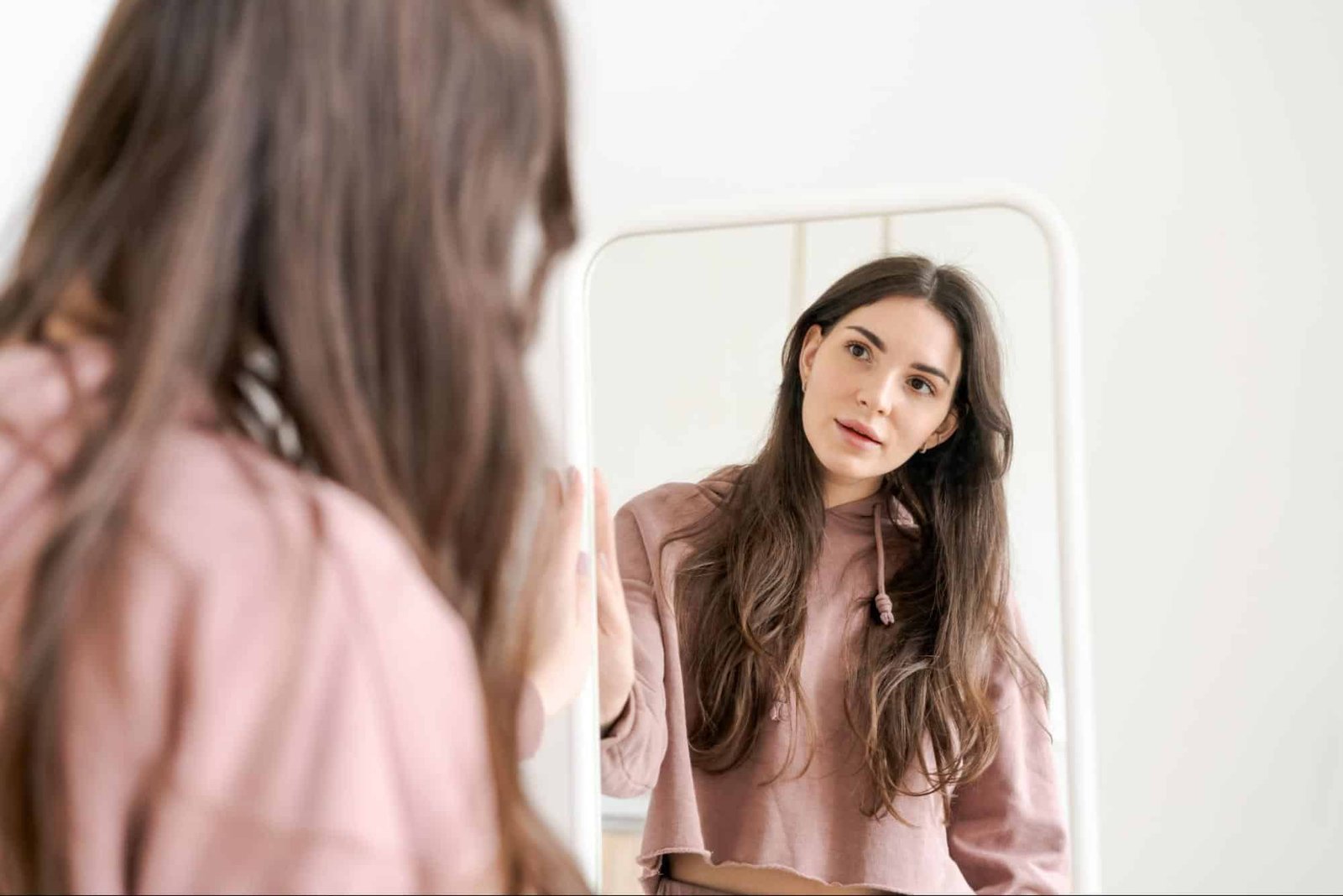 woman looking at herself in a mirror