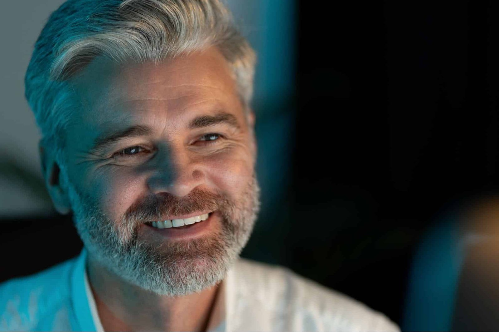 smiling man, showing a few wrinkles