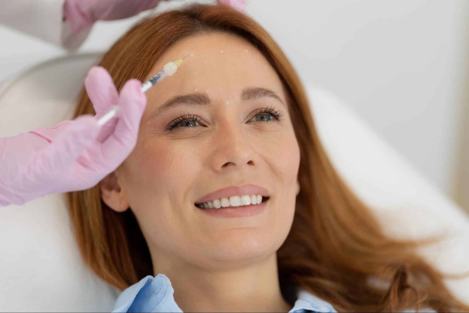 woman receiving neuromodulator facial injection