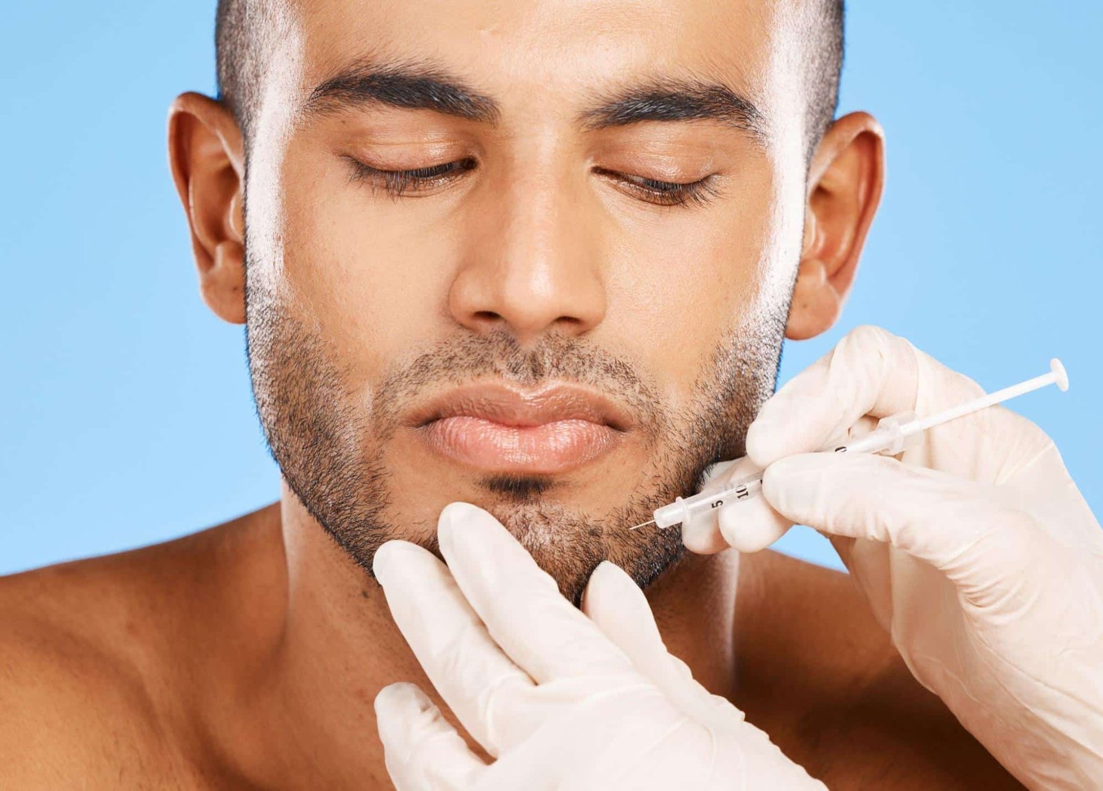 Man receiving a facial injection from a medical provider in a clinical setting, representing the desire to book Botox appointment Weslaco TX