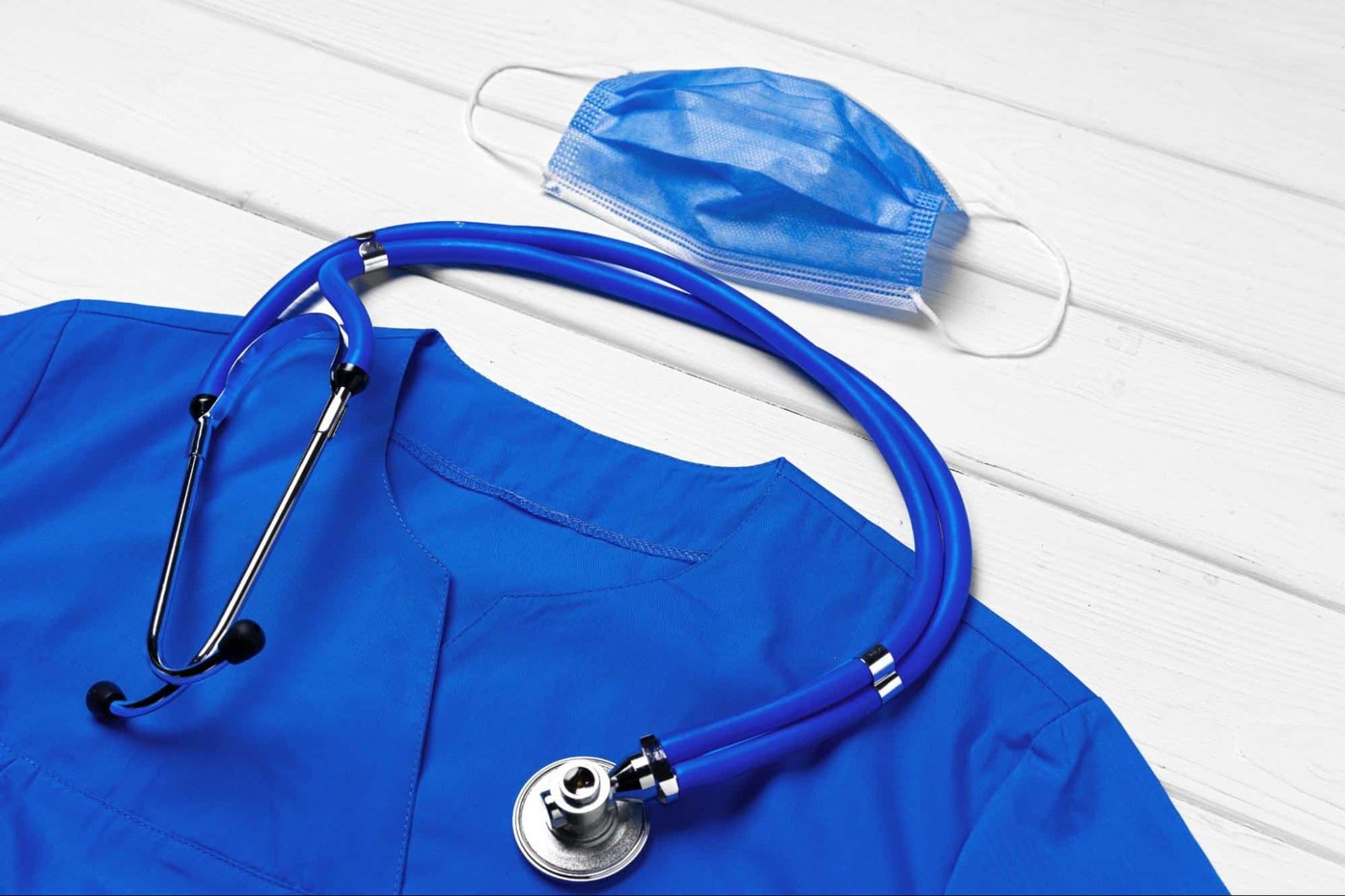 stethoscope, face mask, and primary care provider’s scrub suit