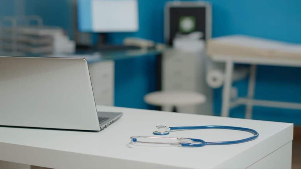 laptop and stethoscope on primary care provider’s table, representing the value of routine physical exam in Weslaco, TX