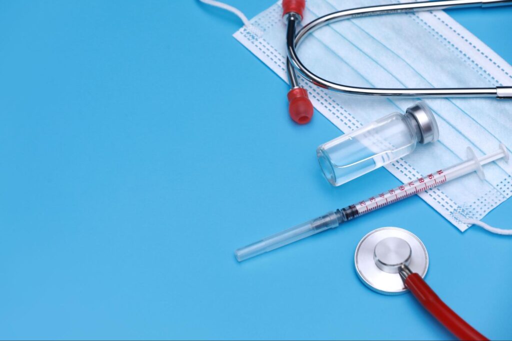 Medical syringe, vial, stethoscope, and face mask used in care at an open late medical clinic in Weslaco, TX.
