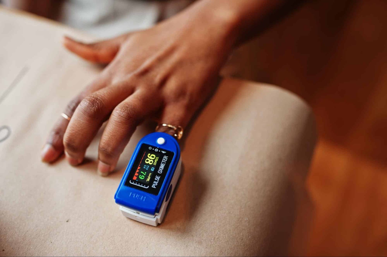 woman using pulse oximeter