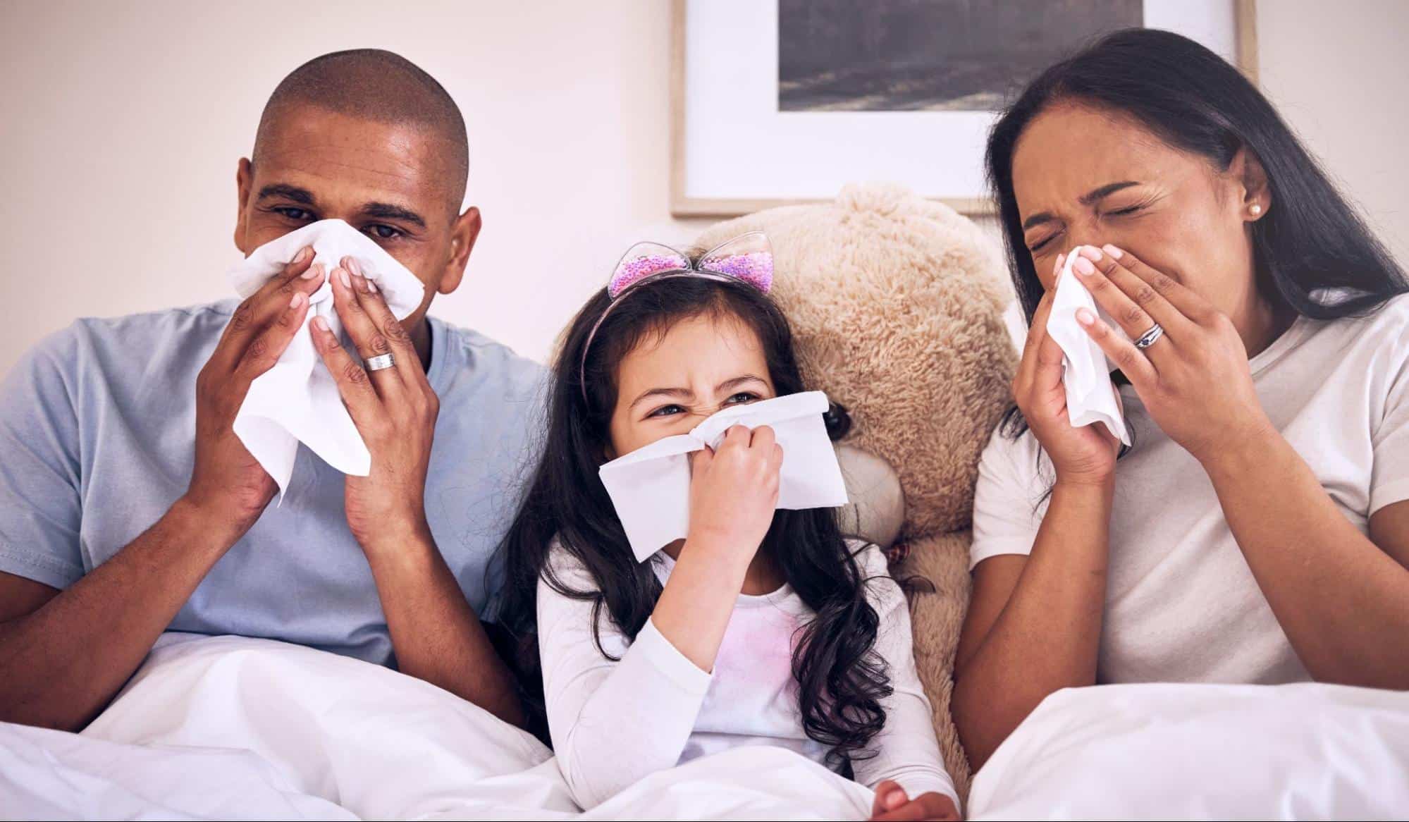 Family with cold symptoms using tissues at home, highlighting need for after hours clinic Weslaco TX care for flu and illness