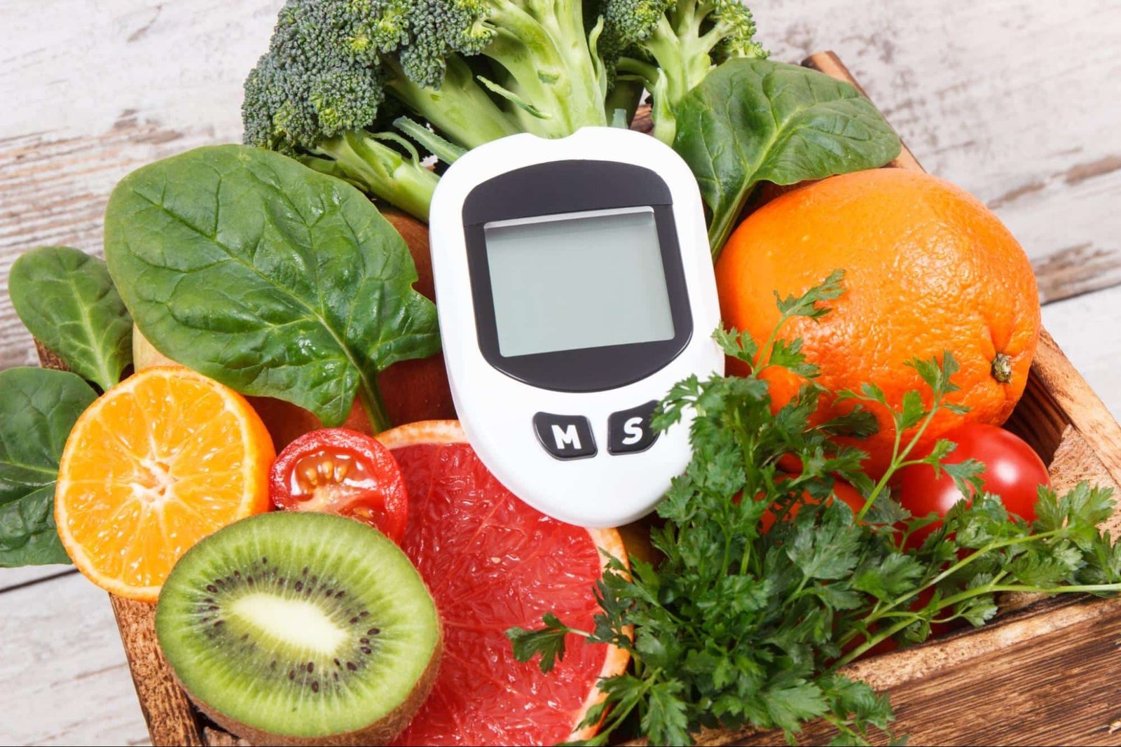 glucometer surrounded by fruits and vegetables