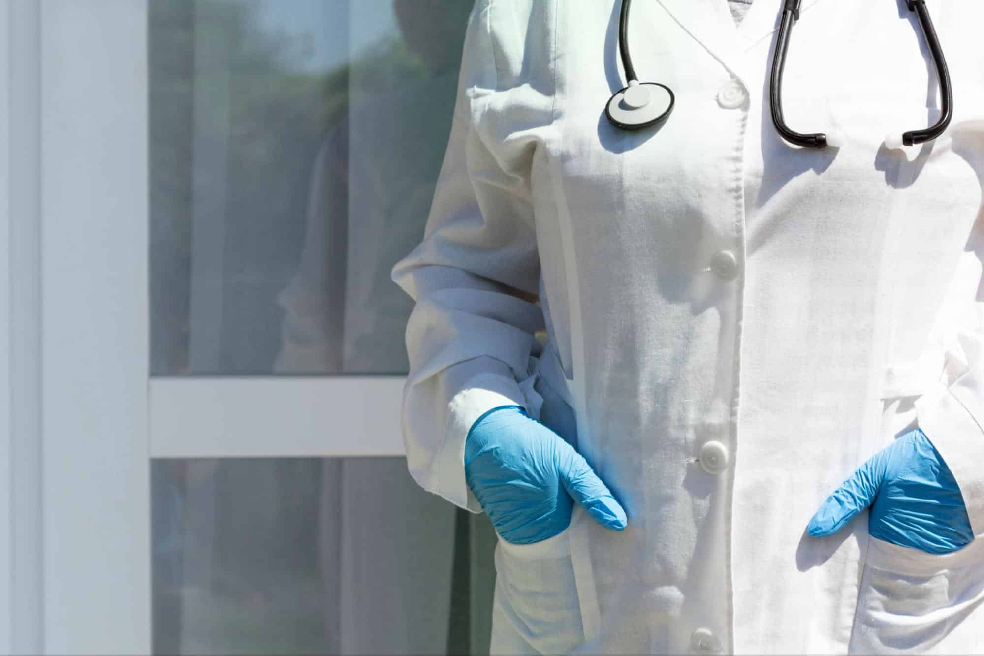 Primary care provider wearing a white coat and stethoscope