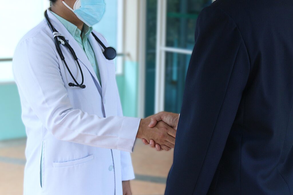 Doctor shaking hands with patient, representing trust in primary care strategies
