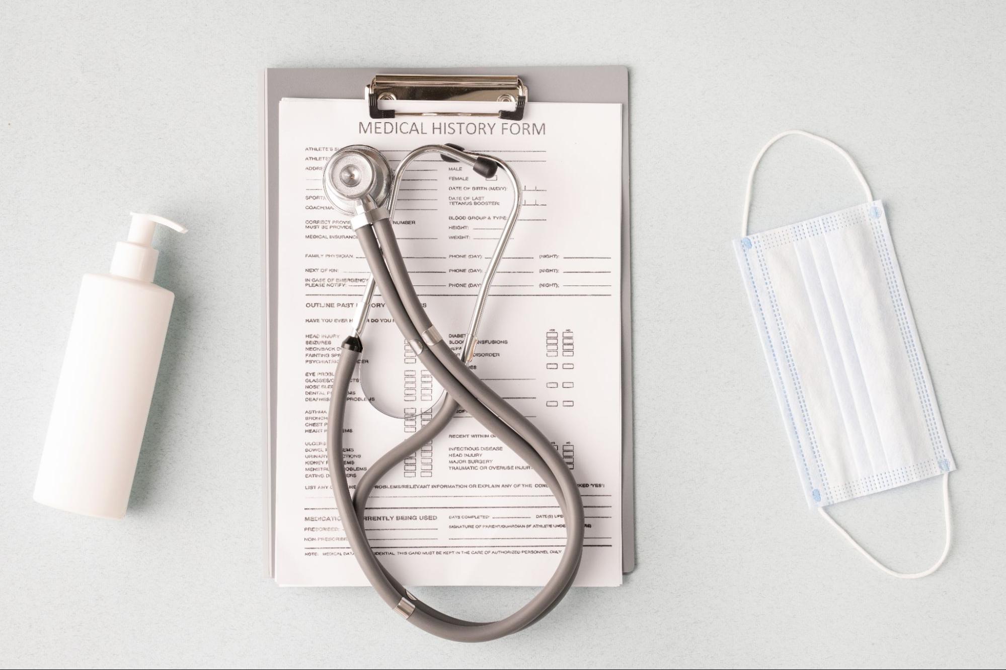 Medical history form with stethoscope and mask