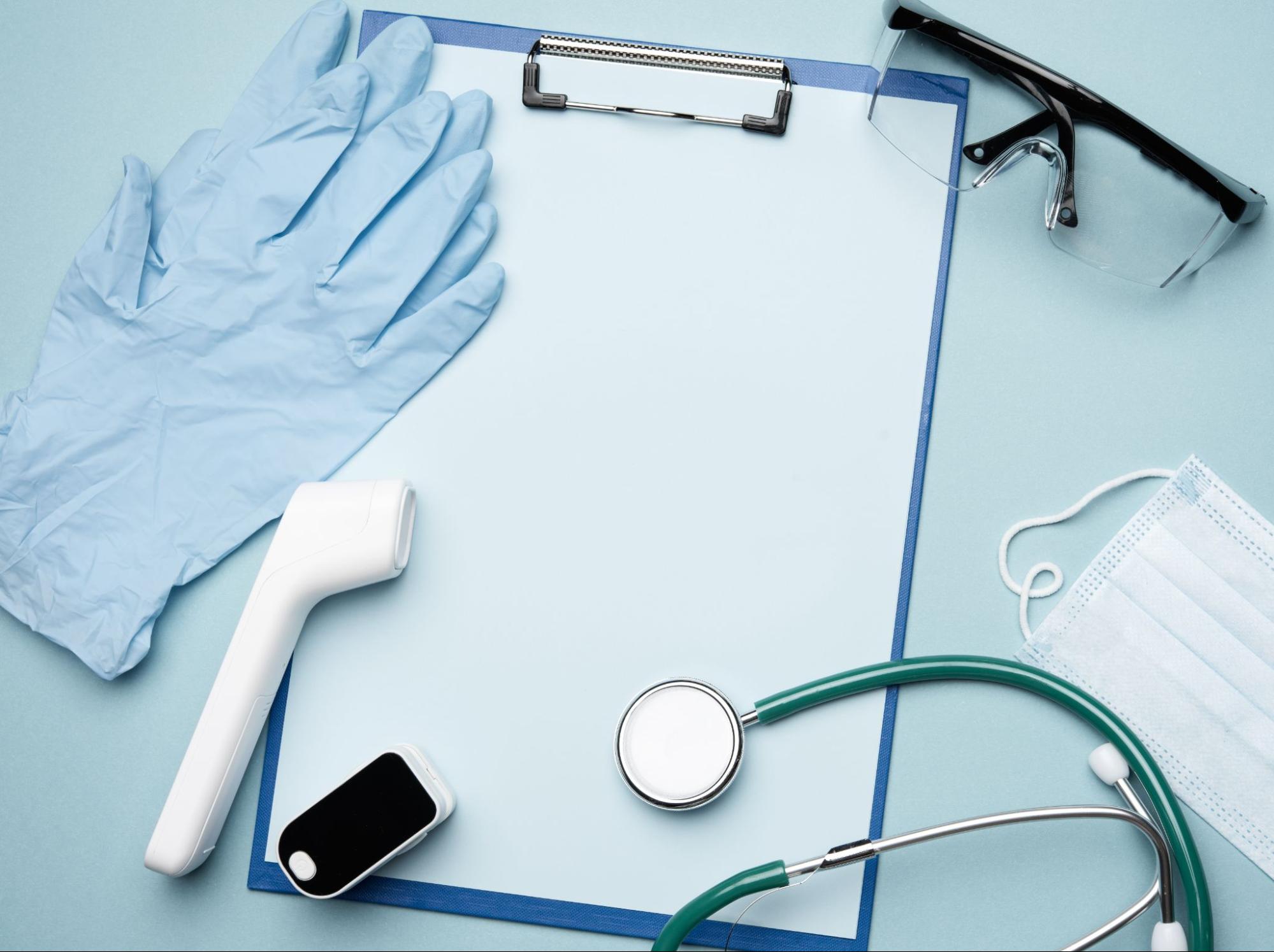 Clipboard with gloves, mask, thermometer, and stethoscope