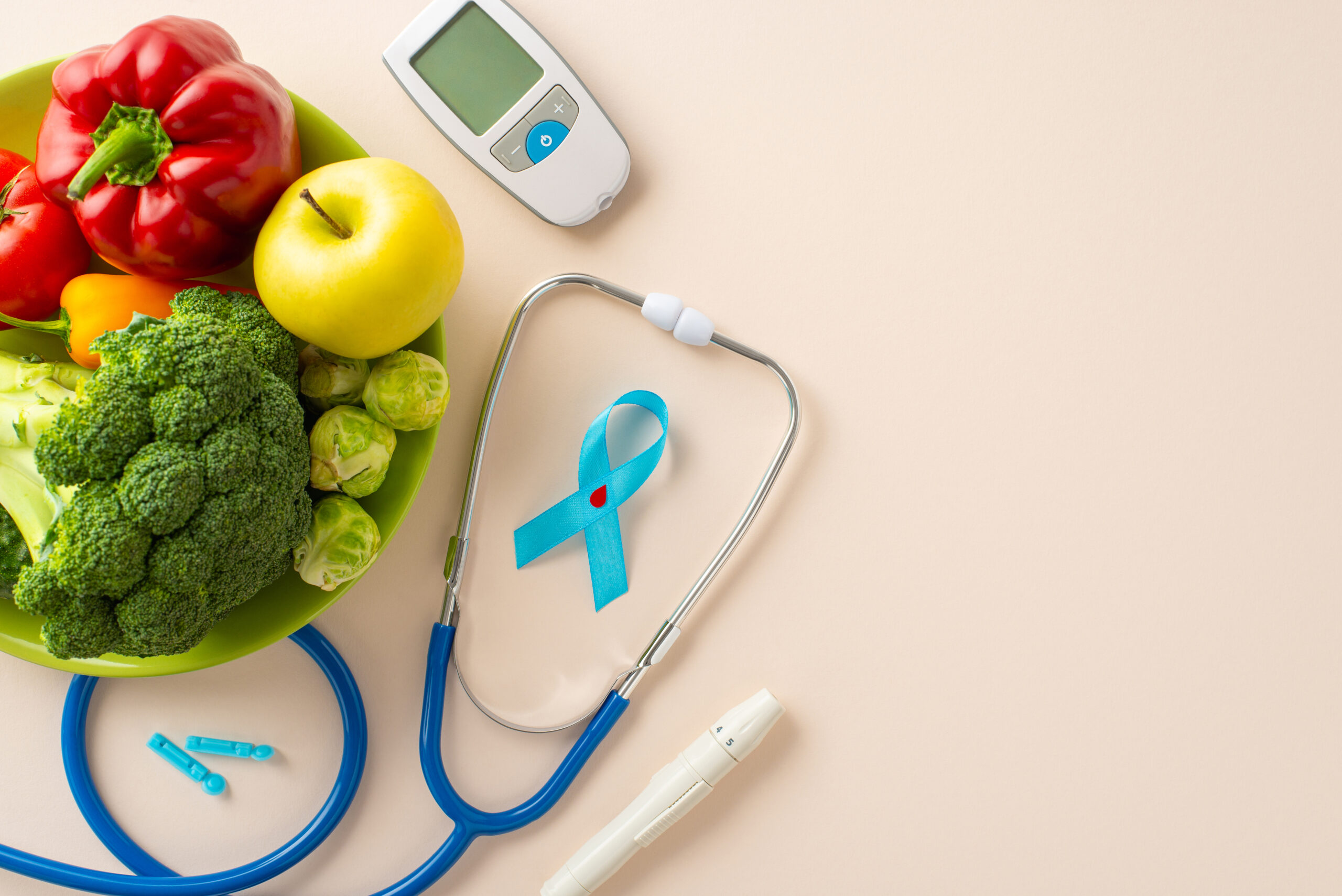 glucose monitor, stethoscope, fruits, and vegetables