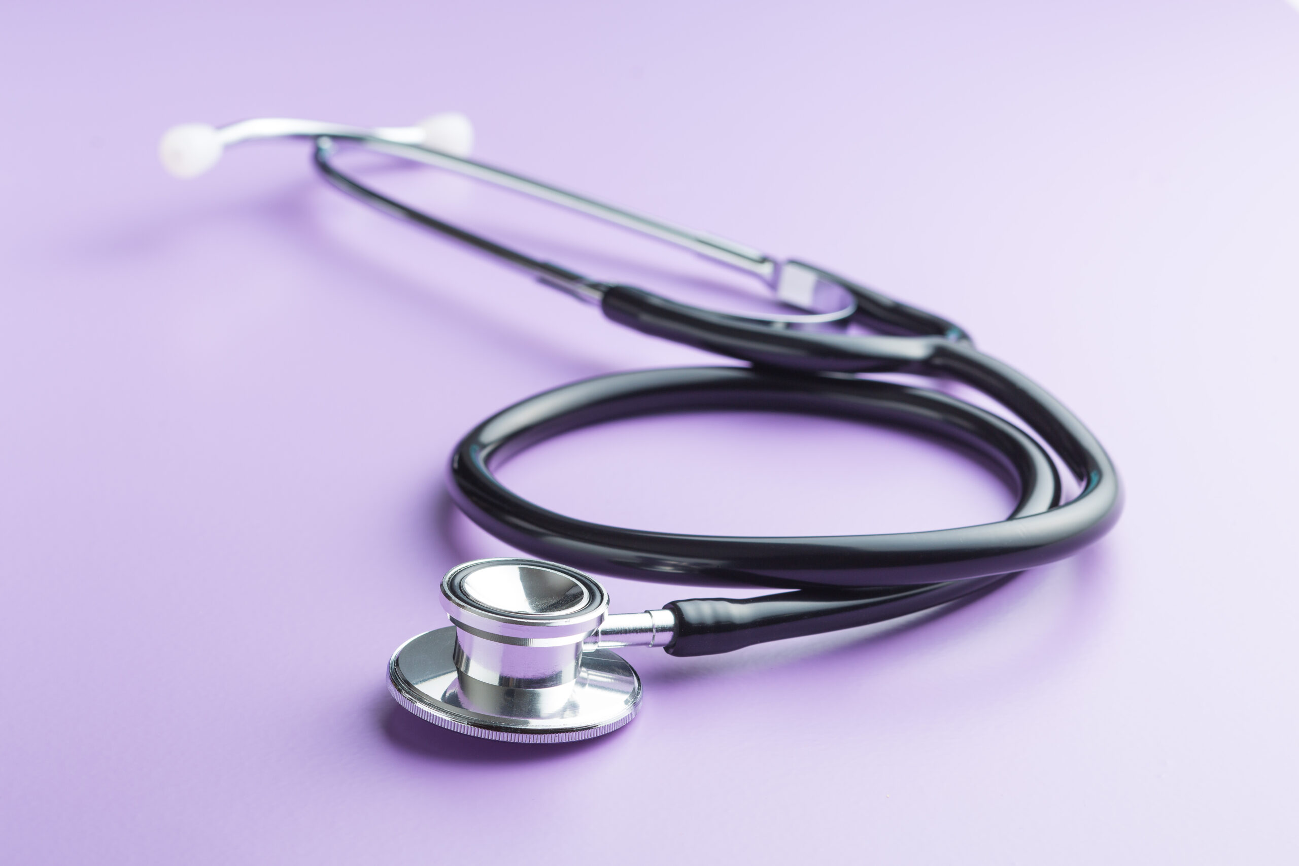 stethoscope on light purple background