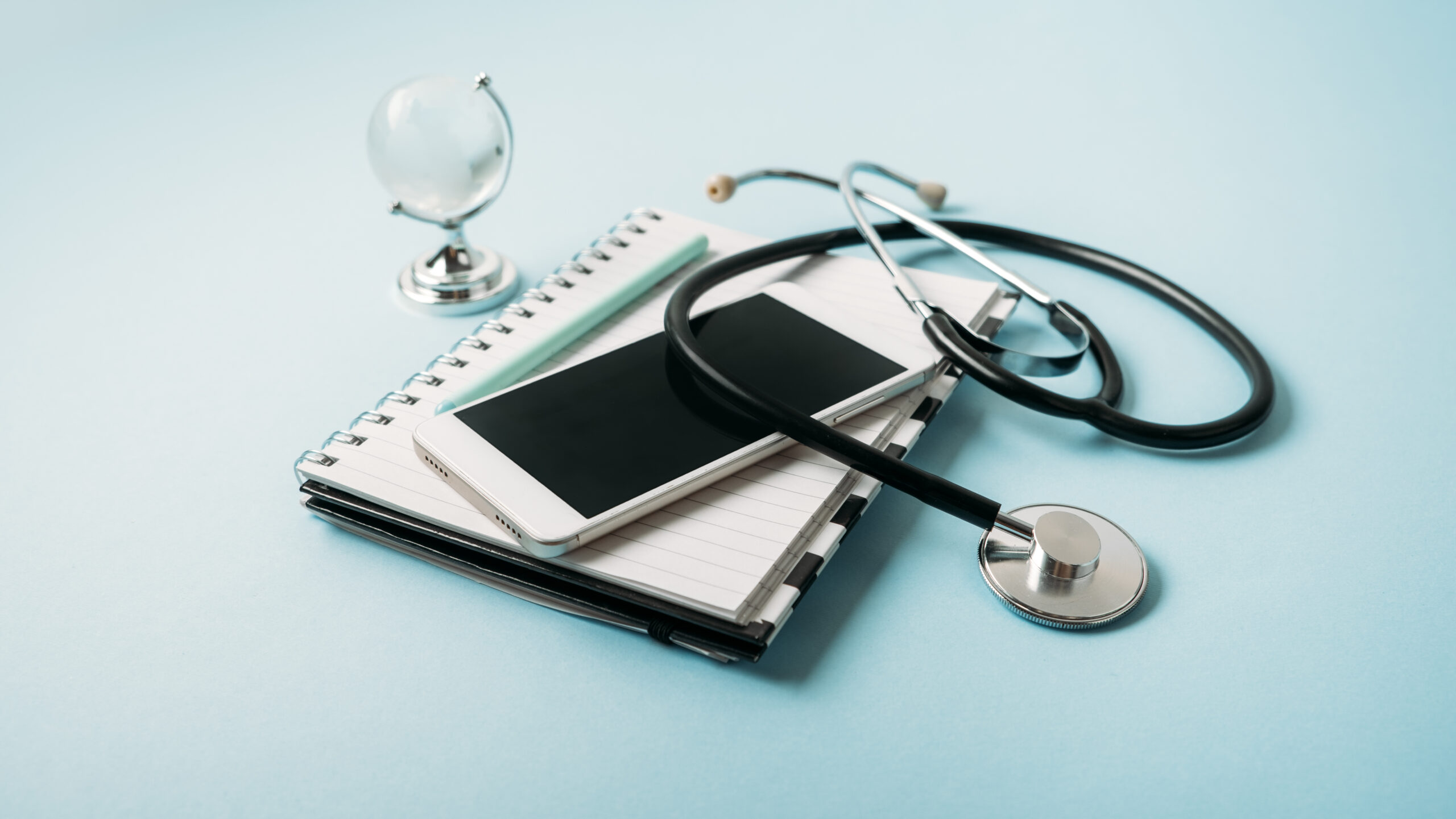 phone, stethoscope, and globe, representing Primary Care With Telehealth in Weslaco